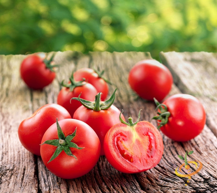 Ace 55 Tomato seeds showing ripe red tomatoes on rustic wooden surface with one sliced to reveal juicy interior
