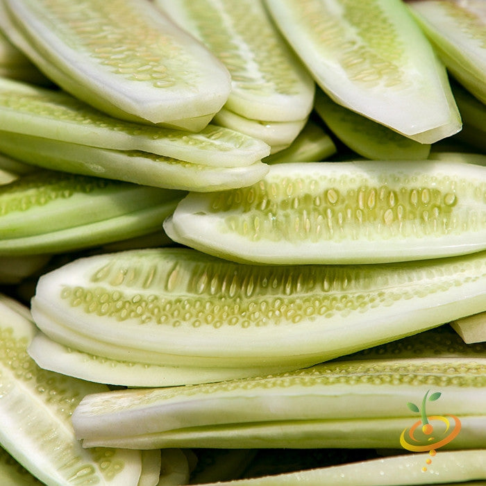 Close-up of sliced White Wonder cucumber variety showing pale green flesh and seeds