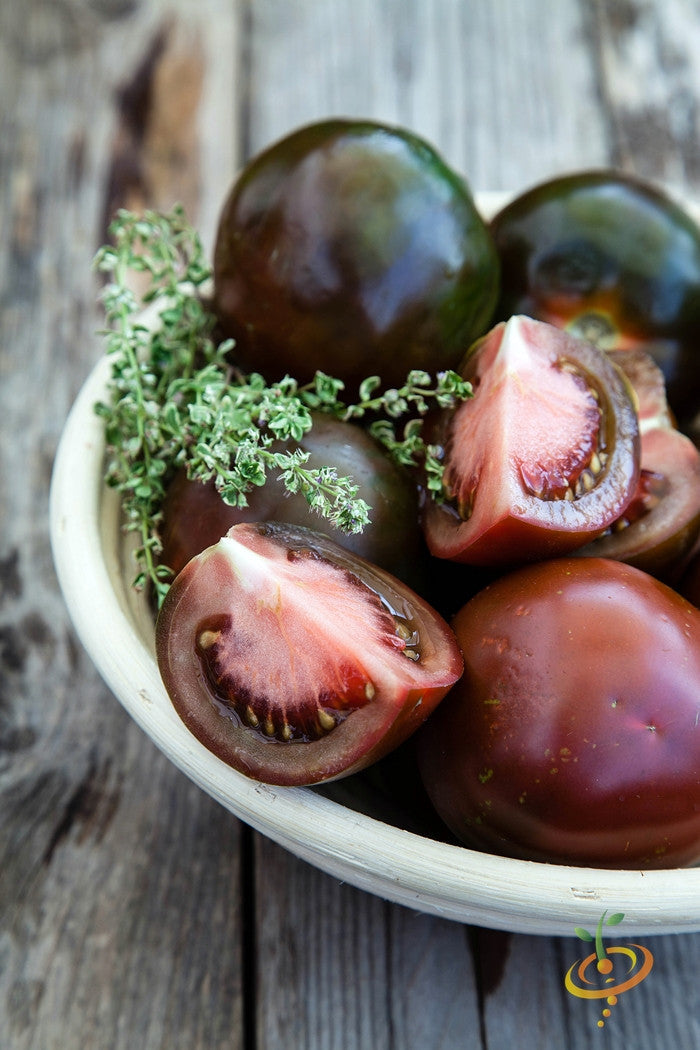 Black Krim indeterminate tomato seeds from SeedsNow, featuring dark red, heirloom tomato seed packets on a white background.