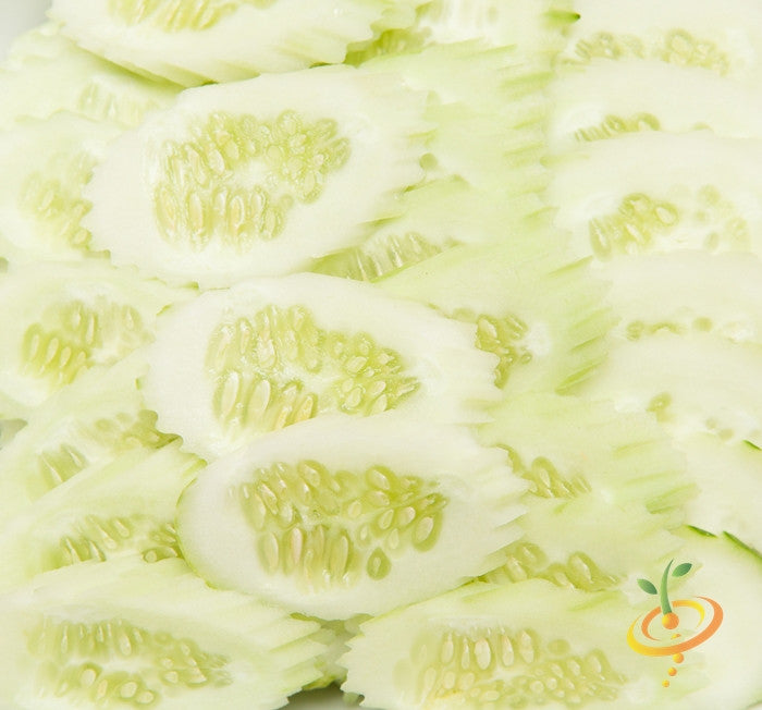 Close-up of thinly sliced white heirloom cucumbers from White Wonder seeds showing seeds and pale green flesh