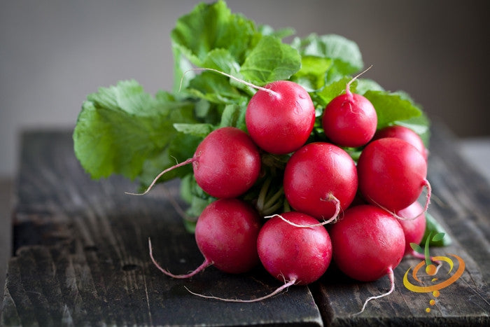 Fresh red cherry radishes with green leaves on a wooden surface, Radish - Champion seeds