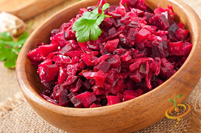 Bowl of chopped deep red Beet - Bulls Blood greens garnished with cilantro