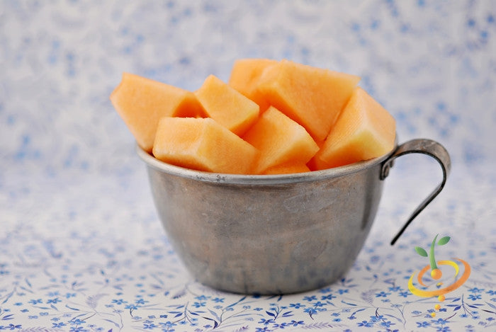 Fresh cantaloupe melon pieces in a rustic cup showcasing Honey Rock seeds fruit quality